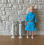 1:12 scale miniature twisted columns in white and gold, set of 2, spiral pedestals shown beside a doll in a blue dress