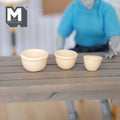 1:12 scale miniature wood mixing bowls in natural finish, set of 3 nesting sizes, lined up on a wood table