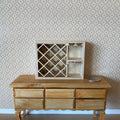 1:12 scale miniature unpainted wood wine rack with diagonal lattice and side shelves, displayed on a wood sideboard