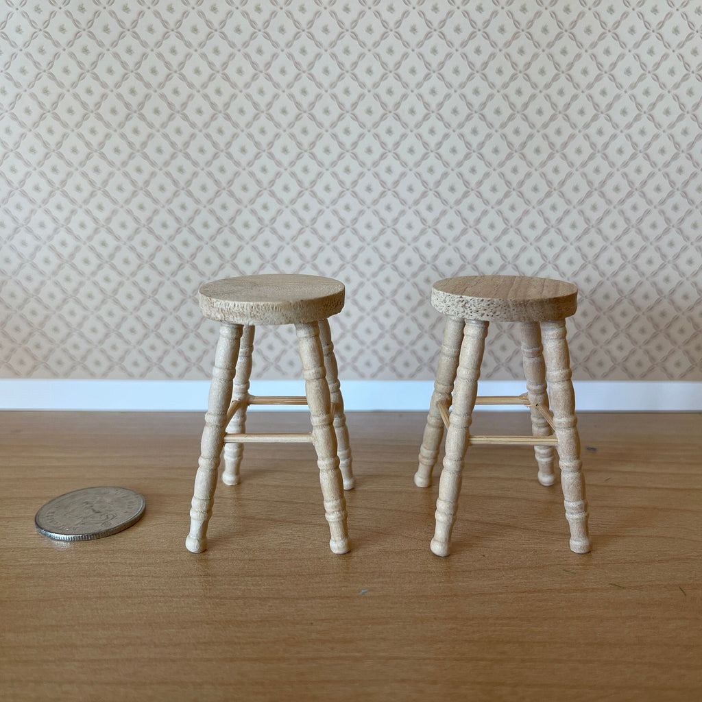 1:12 scale miniature unpainted wood round stools with turned legs, set of 2, shown beside a coin on a wood floor