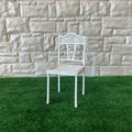 1:12 scale miniature metal garden chair in white with ornate openwork back and woven seat, on green turf