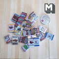 1:12 scale miniature grocery packaging boxes in wood and paper with assorted vintage prints, set of 24, beside a coin