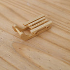 1:12 scale miniature wood sled with curved runners and slatted seat, natural finish, shown on a wood surface