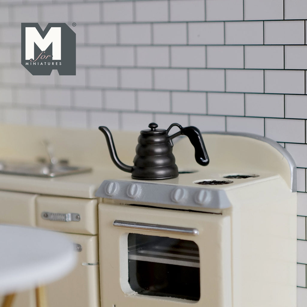1:12 scale miniature black metal gooseneck coffee drip kettle, shown on a cream stove in a tiled kitchen