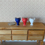 1:12 scale miniature ceramic amphora posy vases, set of 3 in blue, red and white, shown on a wood sideboard with a coin