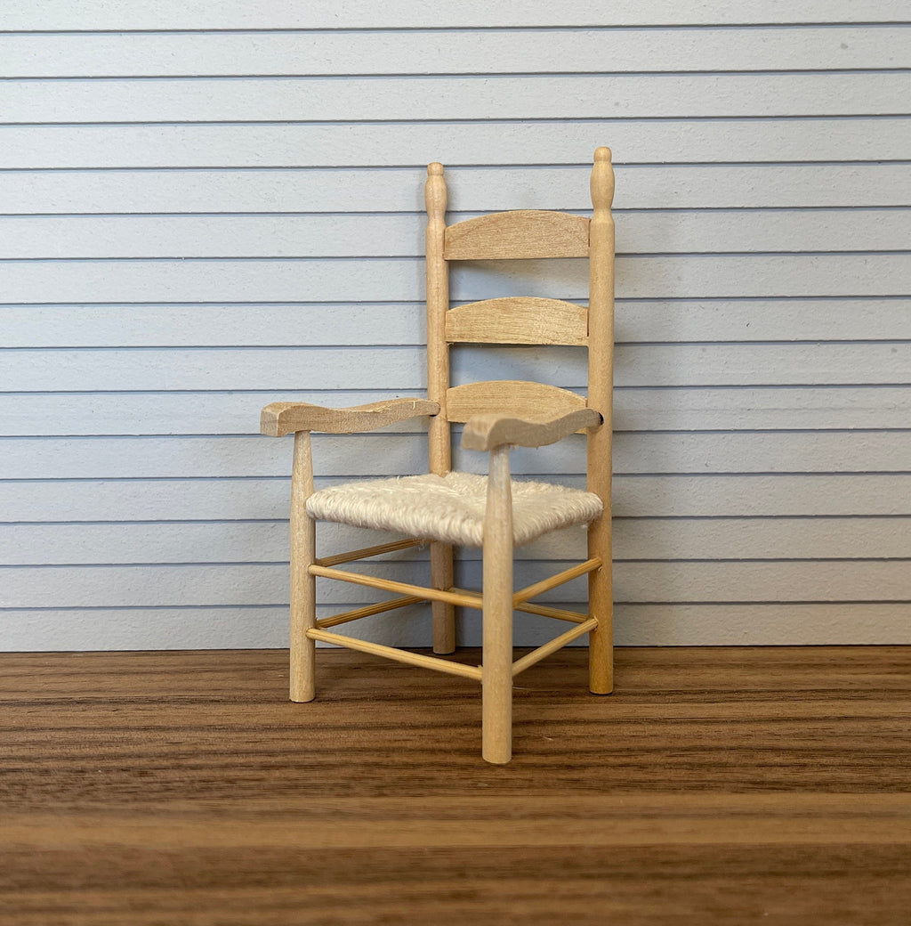 1:12 scale miniature unpainted wood ladderback armchair with woven rush seat, shown against white siding