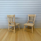 1:12 scale miniature unpainted wood kitchen chairs with spindle backs, set of 2, shown on a wood floor