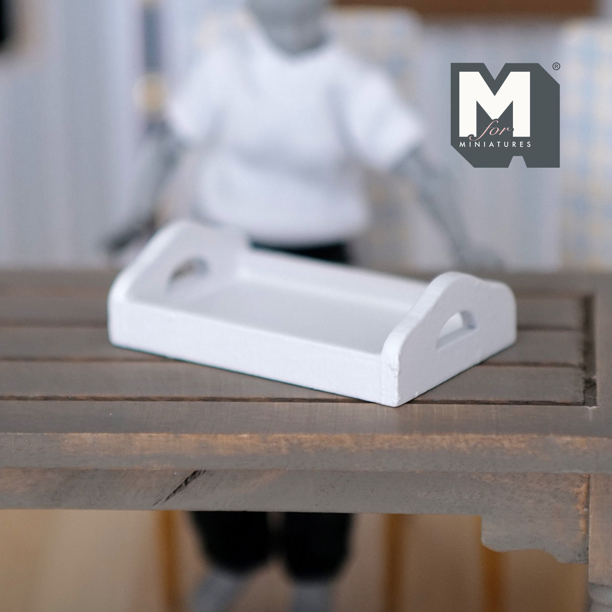 1:12 scale miniature white wood serving tray with cutout handles, shown on a gray slatted table
