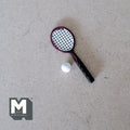 1:12 scale miniature tennis racket and ball set in black and red with white ball, shown on a gray surface
