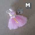 1:12 scale miniature ballet tutu dress in pink with roses and lace, tulle skirt, laid flat beside a coin for scale