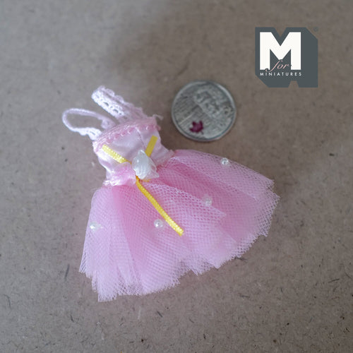 1:12 scale miniature ballet tutu dress in pink with roses and lace, tulle skirt, laid flat beside a coin for scale