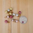 1:12 scale miniature glitter Christmas ball ornaments in gold, silver, red and pink, pack of 12, shown beside a coin for scale
