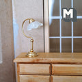 1:12 scale miniature gold metal desk lamp with a white jellyfish shade, non working, shown on a wood dresser