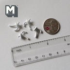 1:12 scale miniature metal single curve wall hooks in white, set of 4, shown beside a coin and a clear ruler