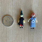 1:12 scale miniature rag dolls, set of 2, a witch in black and a doll in blue gingham dress, shown beside a coin