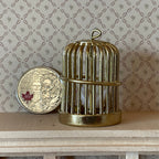 1:12 scale miniature metal round birdcage in gold with bird and pull out tray, shown beside a coin for scale