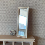 1:12 scale miniature unpainted wood floor mirror, rectangular, leaning on a patterned wall beside a coin for scale