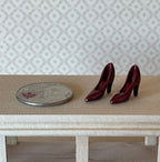 1:12 scale miniature high heel pumps in burgundy, pair, glossy pointed toe shoes shown beside a coin for scale