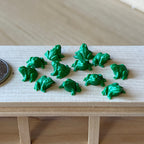 1:12 scale miniature green frog figures, set of 12, glossy frogs grouped on a tabletop