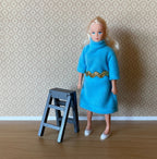 1:12 scale miniature blue gray wood kitchen stepladder, folding with 2 steps, shown beside a figure in a blue dress