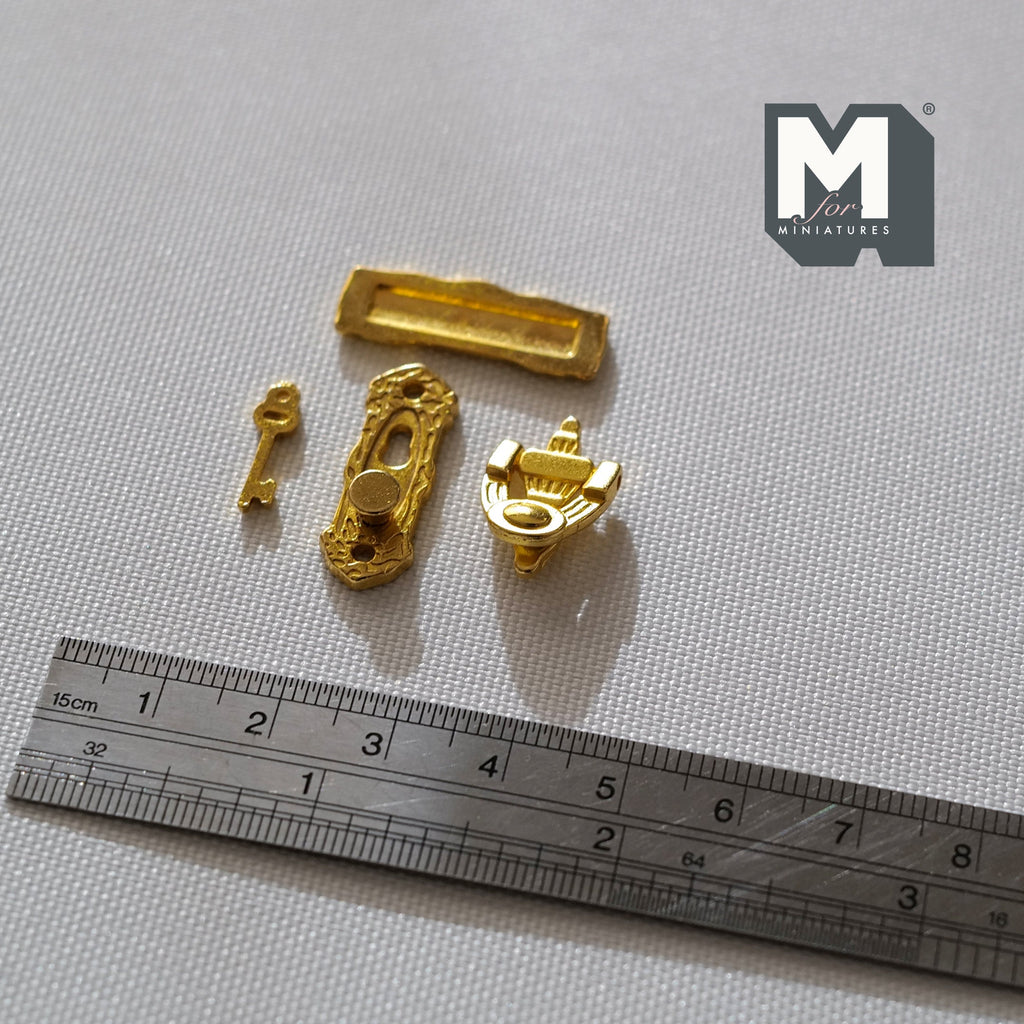 1:12 scale miniature brass door knob, knocker, door plate and key, set of 4, gold tone pieces shown above a ruler