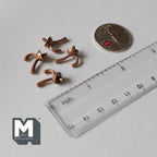 1:12 scale miniature metal double arm wall hooks in copper, set of 4, shown beside a coin and a clear ruler