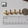 1:12 scale miniature gold metal coat hooks, set of 4, requires mounting, shown in a row with a coin and a ruler