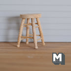1:12 scale miniature unpainted wood round stool with 4 turned legs and stretchers, shown on a wood floor