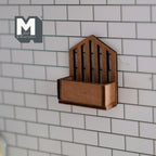 1:12 scale miniature wood wall mail holder in brown with a slatted pointed back, mounted on a white tile wall
