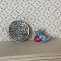 1:12 scale miniature gray kitten playing with a red yarn ball, shown beside a coin for scale