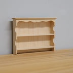 1:12 scale miniature unpainted wood wall shelf with 2 shelves, scalloped top and plank back, shown on a wood surface