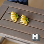 1:12 scale miniature banana bunches, set of 2, yellow bananas with green stems, shown on a gray wood table