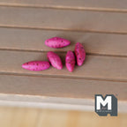 1:12 scale miniature sweet potatoes, set of 5, purple pink skins with dark specks, shown on a wood table
