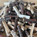 1:12 scale miniature split firewood logs with bark on, 50 g bag, shown in a loose pile of mixed pieces