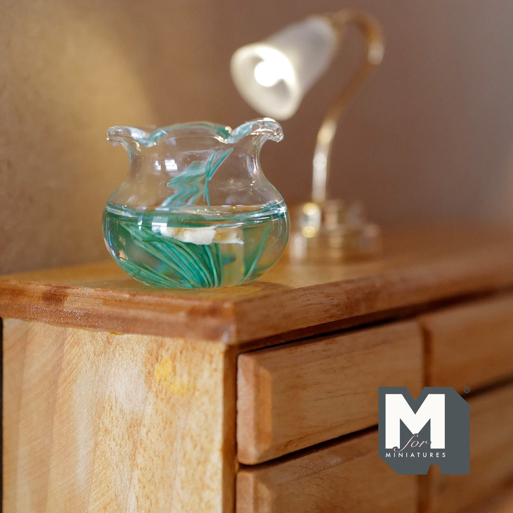 1:12 scale miniature glass fish bowl with 2 goldfish and green plants, ruffled rim, shown on a wood dresser