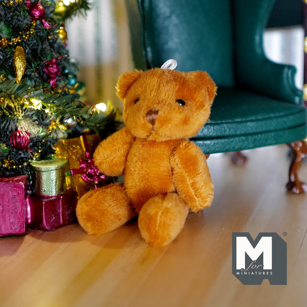 1:12 scale miniature golden brown plush teddy bear with jointed arms and legs, large size, sitting by a Christmas tree