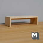 1:12 scale miniature unpainted wood low table with slab ends, simple bench shape, shown on a wood surface