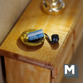 1:12 scale miniature black smoking pipe, gold ashtray and matchbox, set of 3, shown on a wood dresser
