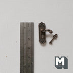 1:12 scale miniature door lock lever plate with key, right hand, set of 2 in antique bronze, shown with a ruler