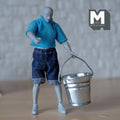 1:12 scale miniature metal water bucket with wire handle, large, galvanized silver, carried by an artist figure