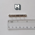 1:12 scale miniature metal key rack in silver, entryway wall rack with hooks, requires mounting, shown above a ruler