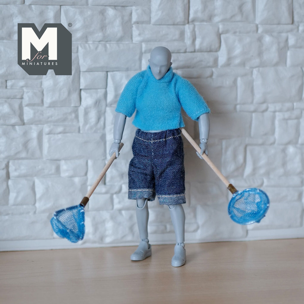 1:12 scale miniature fishing nets with wood handles and blue mesh, set of 2, held by an artist figure