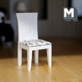 1:12 scale miniature white wood slat back dining chair with floral print seat pad, shown on a wood floor