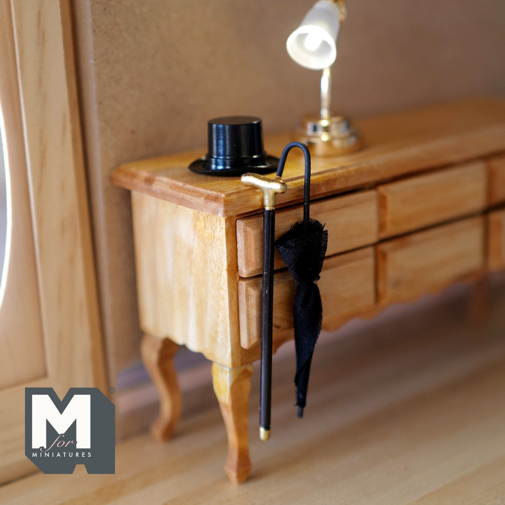 1:12 scale miniature black gentleman's top hat, umbrella and walking cane, set of 3, shown with a wood desk