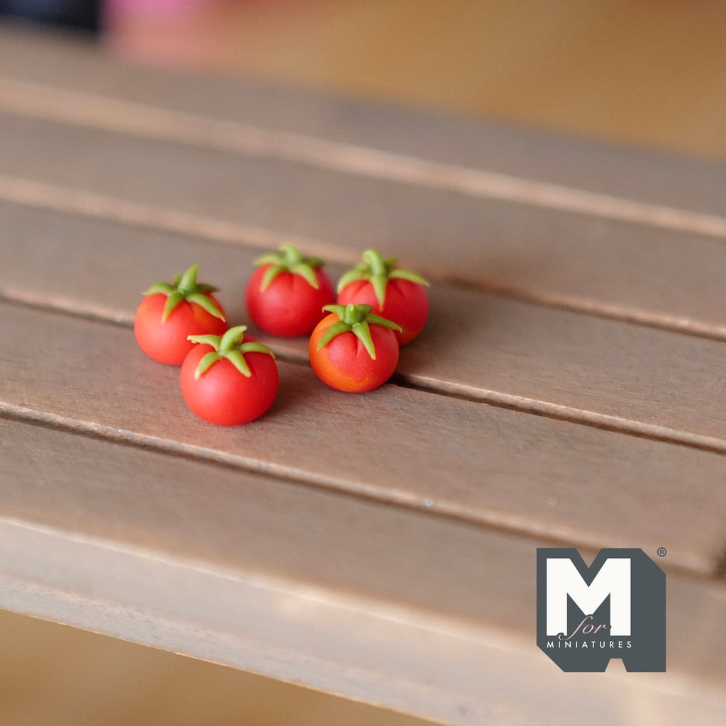 1:12 scale miniature red tomatoes with green stems, set of 5, shown on a wood slat table