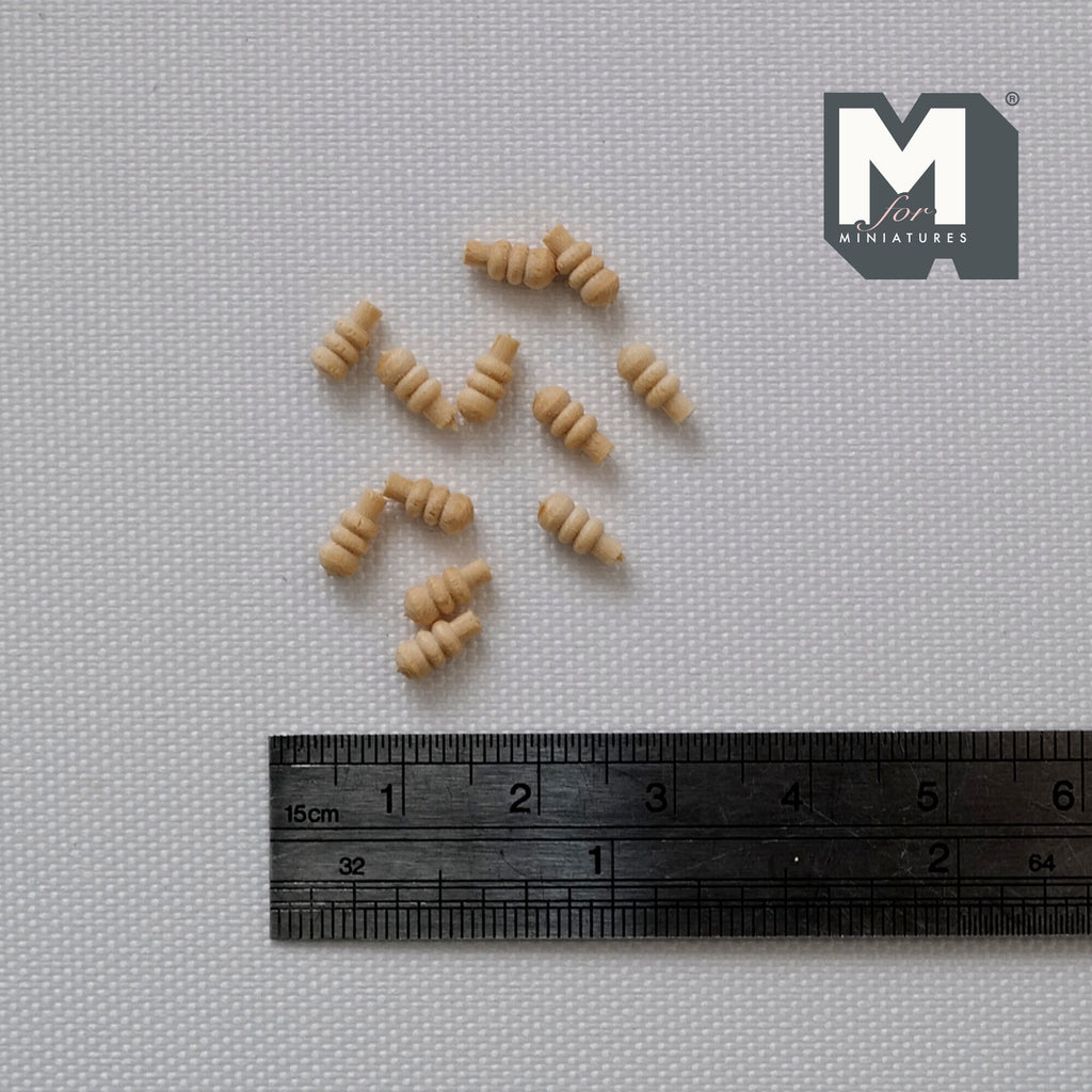 1:12 scale miniature unpainted wood ribbed drawer knobs, set of 12, light natural wood shown scattered on gray fabric