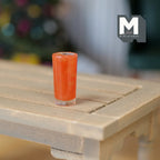 1:12 scale miniature glass of strawberry juice, tall tumbler with red orange drink, shown on a slatted wood table