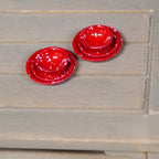 1:12 scale miniature patterned cups and plates in glossy red, set of 6, shown stacked on a wood table