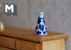 1:12 scale miniature ceramic slim cone vase with blue floral pattern, blue and white, shown on a wood dresser