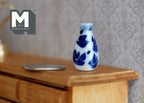 1:12 scale miniature ceramic bottle vase with blue floral pattern, blue and white, on a wood dresser beside a coin